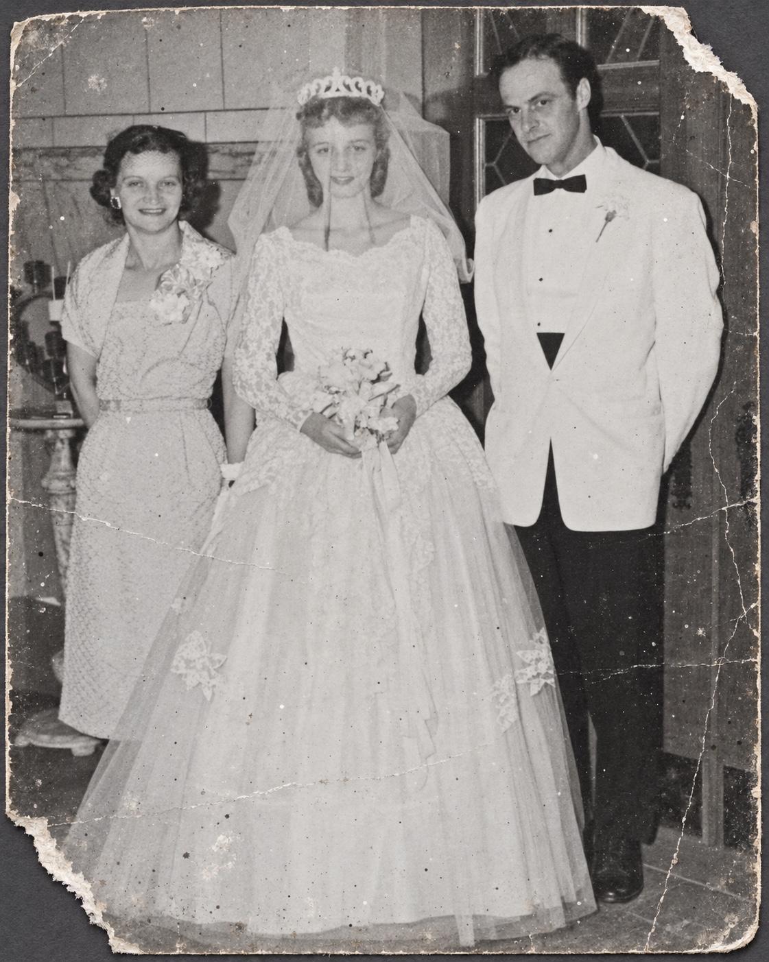 Damaged black-and-white wedding photograph before restoration