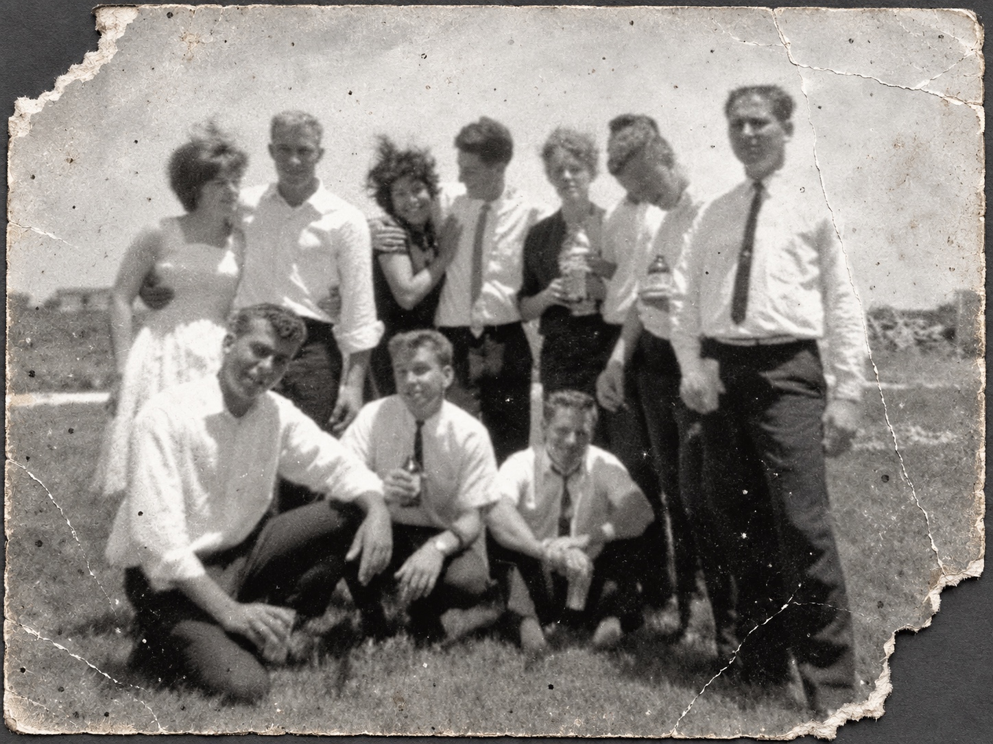 Damaged outdoor group photograph before restoration