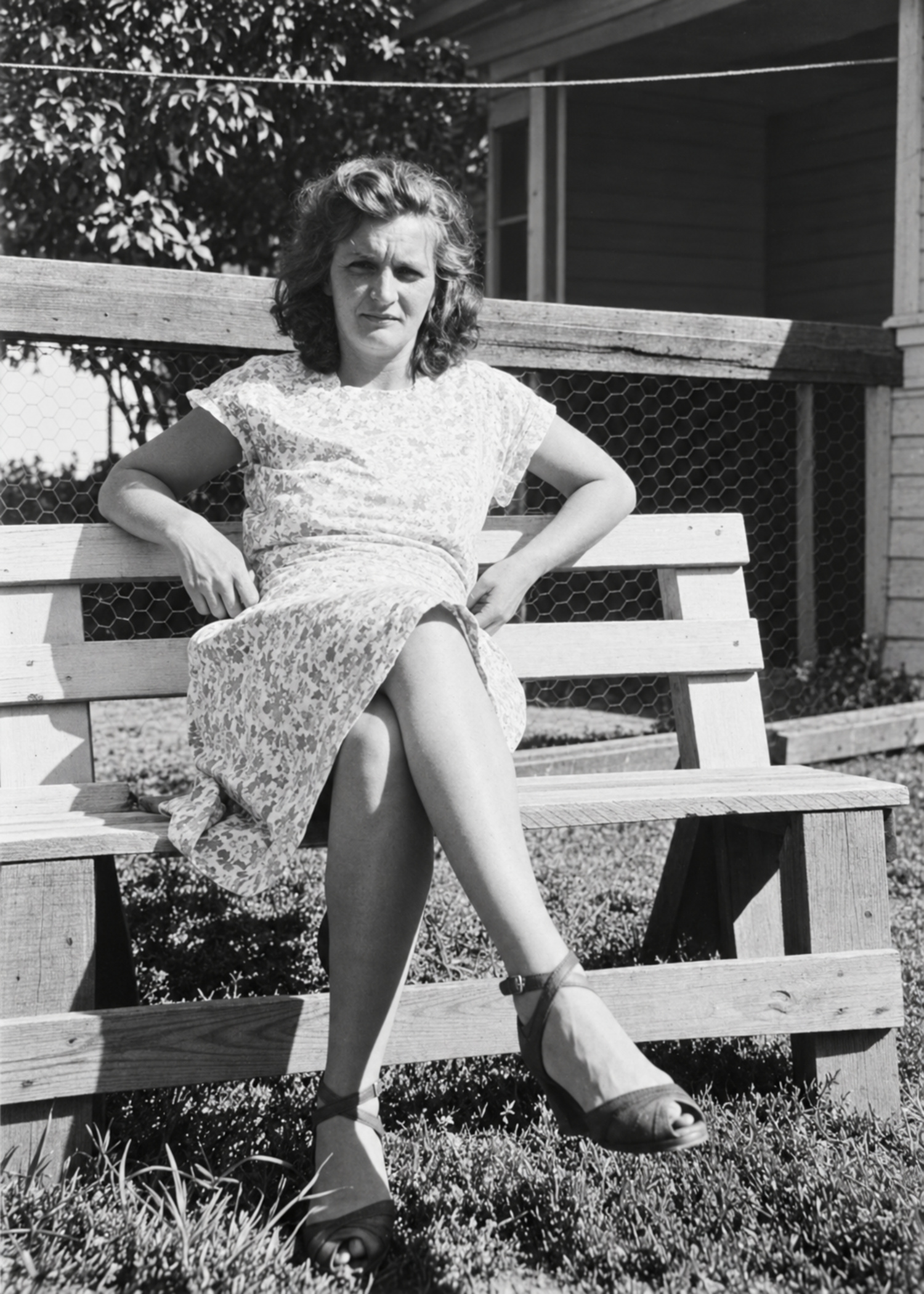 Restored black-and-white outdoor portrait of a seated woman