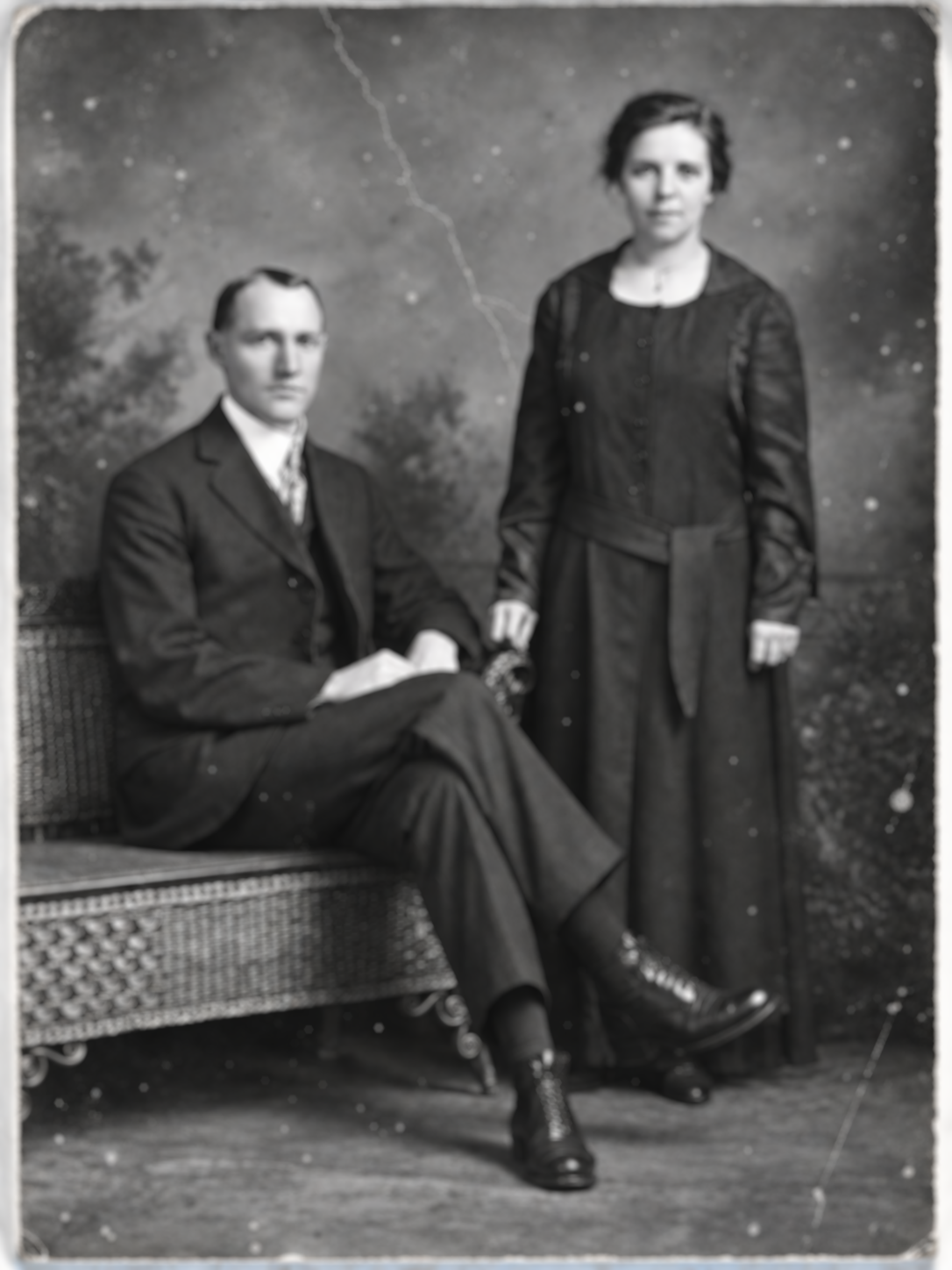 Damaged black-and-white studio portrait before restoration